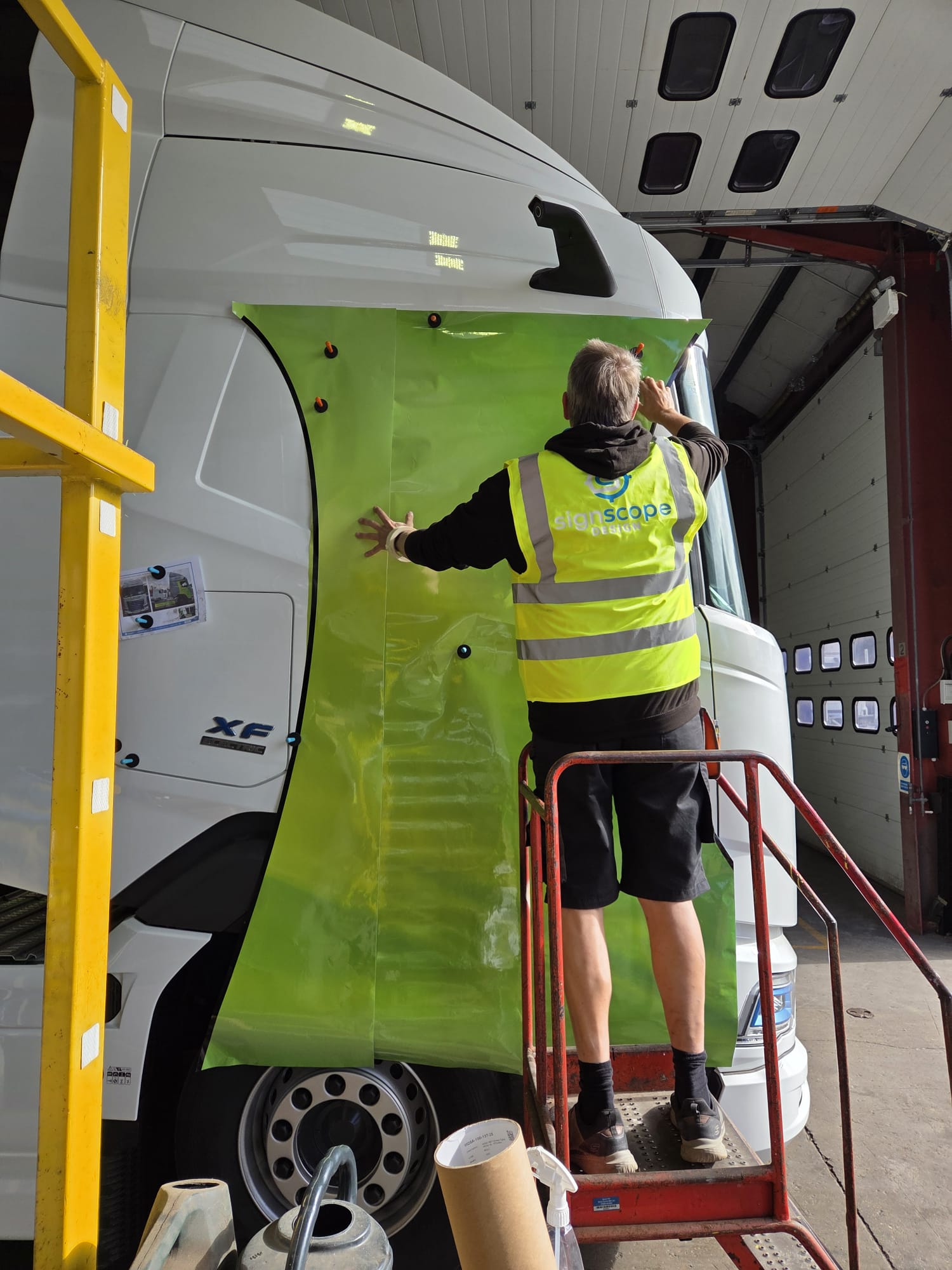 Signscope fitter installing Darcica truck graphics